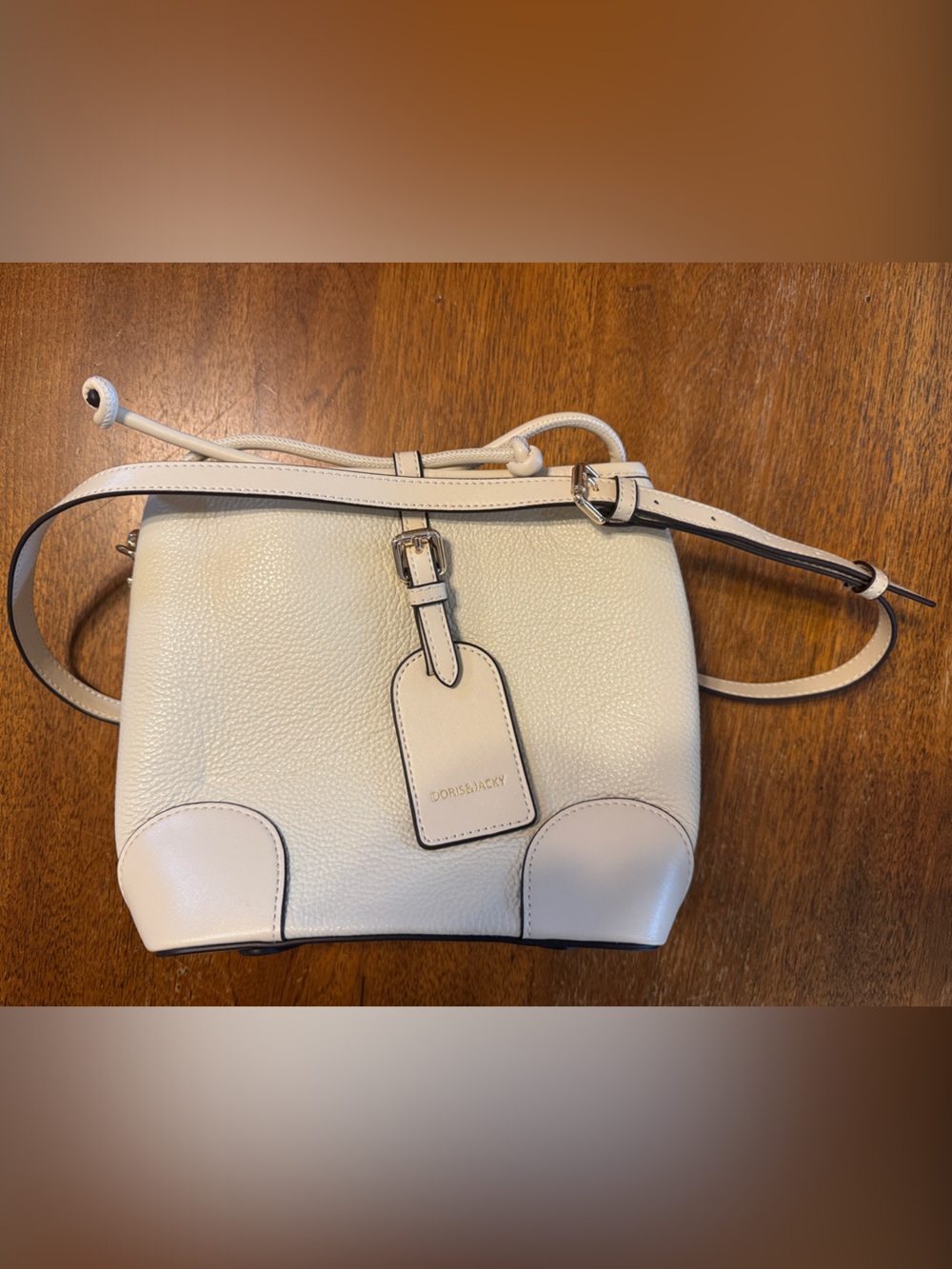 Doris & Jacky Cream Pebbled Leather Crossbody with Buckle Tag
